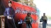 Afghan police stand beside a portrait of former Afghan King Ghazi Amanullah Khan during Independence Day celebrations in Jalalabad.