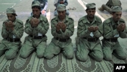 Cadets from the Afghan Local Police pray at the police academy on the outskirts of Jalalabad on June 20.