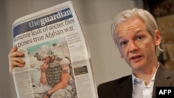 The Australian founder of the whistle-blowing website WikiLeaks, Julian Assange, holds up a copy of "The Guardian" at a press conference in London on July 26.