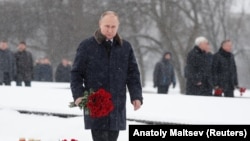 Russian President Vladimir Putin lays flowers during a ceremony to mark the 75th anniversary of the Soviet breakthrough in the Nazi Siege of Leningrad in World War II, in St. Petersburg on January 18. 