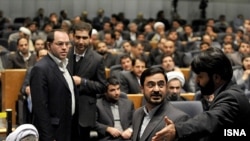 Tehran's former prosecutor, Said Mortazavi (center), may be exiting the scene. What does his apparent downfall tell us about the country's political landscape and the ongoing trial of strength between the president and his pragmatic conservative critics?