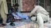 People attend to a man injured in a blast in the Afghan city of Mazar-e Sharif on March 11. 