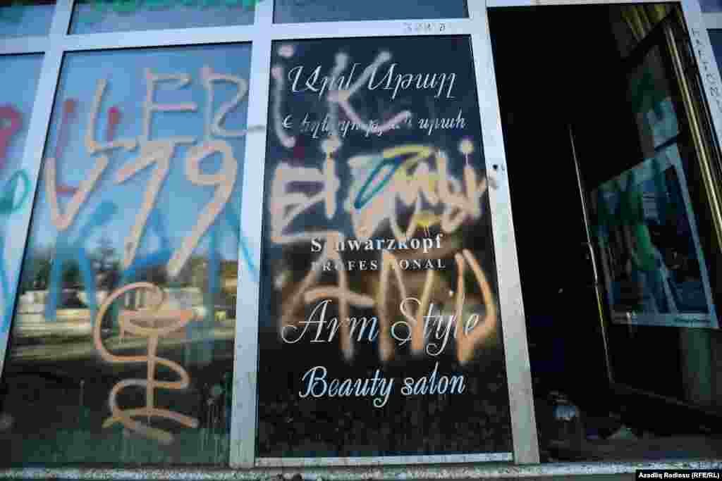 A Hadrut shop window covered in graffiti.&nbsp;