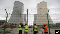 Workers fix barbed wire on a fence surrounding the Rooppur Nuclear Power Plant in Ishwardi in Bangladesh on October 4. 