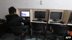 A man browses the Internet at a cafe in central Tehran in January after Iran officially launched its cyberpolice unit to confront Internet crimes and counter social networks that spread "espionage and riots," according to its police chief.