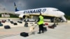 Security with a sniffer dog check the luggage of passengers in front of the Ryanair flight carrying journalist Raman Pratasevich in Minsk on May 23.