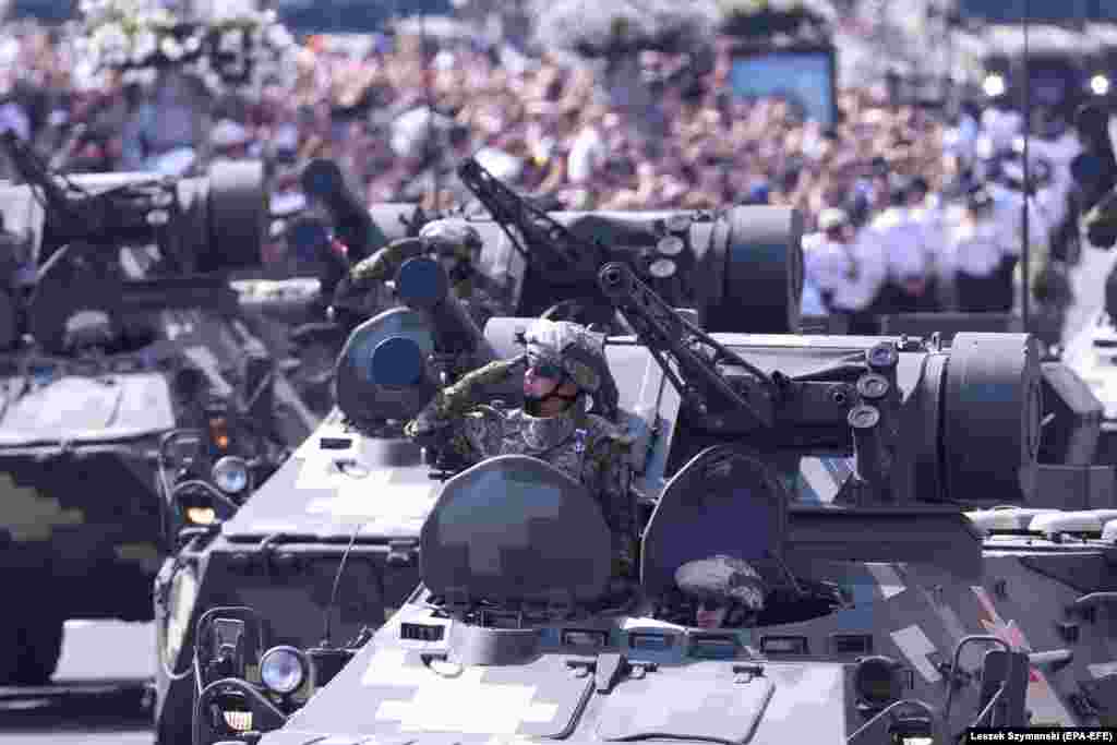 Ukrainian military vehicles drive past the crowd during the parade.&nbsp;