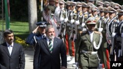 President Mahmud Ahmadinejad (left) and his Brazilian counterpart Luiz Inacio Lula da Silva review a guard of honor in Tehran on May 16.