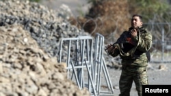 A Kosovo Force (KFOR) soldier from Armenia stands guard at the closed Serbia-Kosovo border crossing of Jarinje.