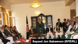 Afghan President Hamid Karzai (second left) speaks with members of the new Afghan Peace Council during its inaugural session in Kabul.