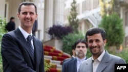 Iranian President Mahmud Ahmadinejad (right) with Syrian President Bashar al-Assad in Tehran