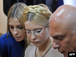 Yulia Tymoshenko is flanked by her husband, Oleksandr, and her daughter, Yevhenia, react after the verdict was anounced in a district court in Kyiv in October.