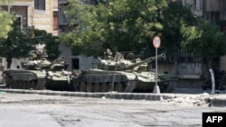 Government tanks in the Midan neighborhood of Damascus on July 20