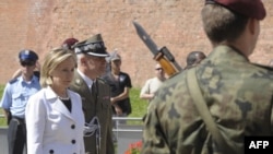 In Krakow, U.S. Secretary of State Hillary Clinton lays a wreath at the monument to Polish officers murdered by Soviet forces in Katyn in 1940.