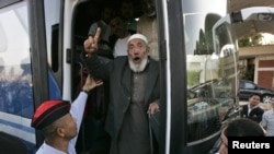 An activist who was seized during the aid-convoy raid bound for Gaza gestures upon his arrival in Jordan on June 2.