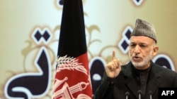 President Hamid Karzai speaks during the opening of the Loya Jirga, in Kabul on November 21, 2013.