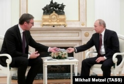 Russian President Vladimir Putin (right) meets with Serbian President Aleksandar Vucic at the Kremlin in Moscow on October 2.