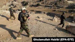 Afghan soldiers conduct a security check during operations in Achin earlier in 2018.