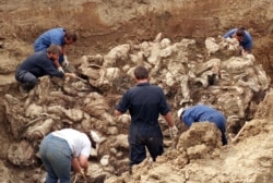 A mass grave of some of the victims of the Srebrenica genocide being uncovered in 1996.