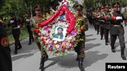 Soldiers carry wreaths and a portrait of Arsala Rahmani, a senior member of the High Peace Council who was assassinated by Afghan insurgents earlier this month.