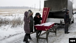 Relatives attend the funeral of 11-year-old Artem Lytkin, who was killed during shelling on Debaltseve on January 19. 