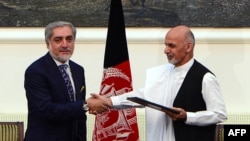 The NATO chief said both Afghan presidential candidates Abdullah Abdullah (left) and Ashraf Ghani pledged to sign the agreements in their joint message to the NATO summit in Wales on September 4.