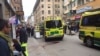 Emergency services help the injured near the scene where a truck crashed into a department store in central Stockholm in April. An Uzbek man has been charged with deliberately ramming the shop, killing four people. 