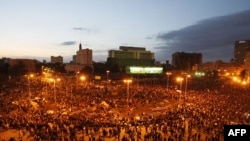 Egyptian demonstrators gather at dusk in Tahrir Square in Cairo on January 31 2011