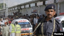 A policeman stands stands guard after an incident in Quetta on May 17, in which five alleged suicide bombers were shot dead by Pakistani security forces. 