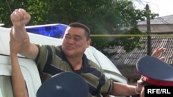 Ramazan Esergepov being escorted by police to the courthouse in Taraz on August 8.