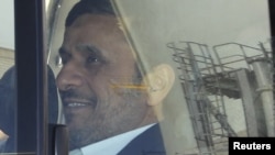 Iranian President Mahmud Ahmadinejad is seen through the window of a vehicle as he tours an industrial site in Kerman province on January 26.