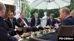 U.S. President Barack Obama (second from left) and Russian Prime Minister Vladimir Putin (right) meet at the latter's country residence outside Moscow in July 2009.