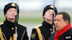 Venezuelan President Hugo Chavez inspects the honor guards on his arrival in Moscow on October 14.