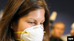 A woman wears a mask as she arrives from Mexico at Rhein Main airport in Frankfurt Main.