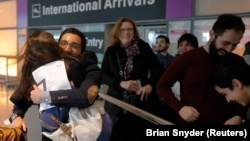 Behnam Partopour, a Worcester Polytechnic Institute student from Iran, is greeted by his sister Bahar (left) at Logan Airport after he cleared U.S. customs and immigration on an F1 student visa in Boston, Massachusetts, on February 3.