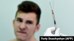 A nurse prepares a measles vaccine at a school in a village close to the western Ukrainian city of Lviv.