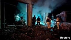 Rescuers work at the site of a Russian missile strike in Kryviy Rih, Ukraine, on February 23.