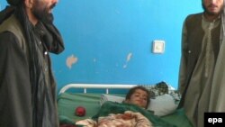 An Afghan boy injured in an alleged international air strike that hit a wedding ceremony in 2008 receives medical treatment at a hospital in Kandahar.