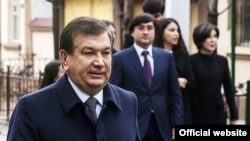  Uzbek President Shavkat Mirziyoev with his family. Mirziyoev's son-in-law, Oibek Tursunov, can be seen standing behind him on the right. (file photo)