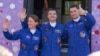 NASA astronaut Loral O'Hara (left) and cosmonauts Oleg Kononenko and Nikolai Chub wave as they prepare for the launch of a Russian spacecraft from the Baikonur Cosmodrome in Kazakhstan on September 15. 