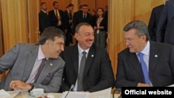 Georgian President Mikheil Saakashvili (left), Azerbaijani President Ilham Aliyev, and Ukrainian President Viktor Yanukovych confer during the EU's Eastern Partnership summit in Warsaw.