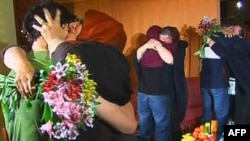 A screen grab from Iranian state Press TV shows the first tearful reunion of the mothers with detained Americans Josh Fattal, Sarah Shourd, and Shane Bauer (left to right) in Tehran on May 20.