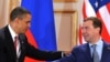 Obama and Medvedev shake hands after signing the new nonproliferation treaty in Prague.