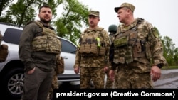 Ukrainian President Volodymyr Zelenskiy (left) visits soldiers at the front line in the Kharkiv region.