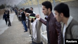 Iranian students form a human chain around the uranium-conversion facility in Isfahan to show their support for Iran's nuclear program in November 2011.