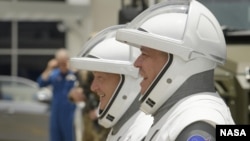 Astronauts Doug Hurley (left) and Robert Behnken on their way to SpaceX's Crew Dragon spacecraft.