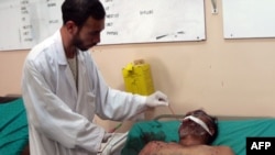 A wounded man receives treatment from a doctor at a hospital in Kandahar following the blast.