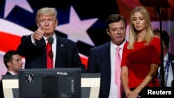 Then-Republican presidential nominee Donald Trump gives a thumbs-up as his then-campaign manager, Paul Manafort (center), and daughter Ivanka look on at the Republican National Convention in Cleveland on July 21. 