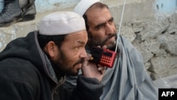 Afghan men listen to a radio in Jalalabad. (file photo)