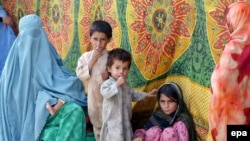 A woman and her family arrive in Peshawar after fleeing the restive Bajaur tribal area.